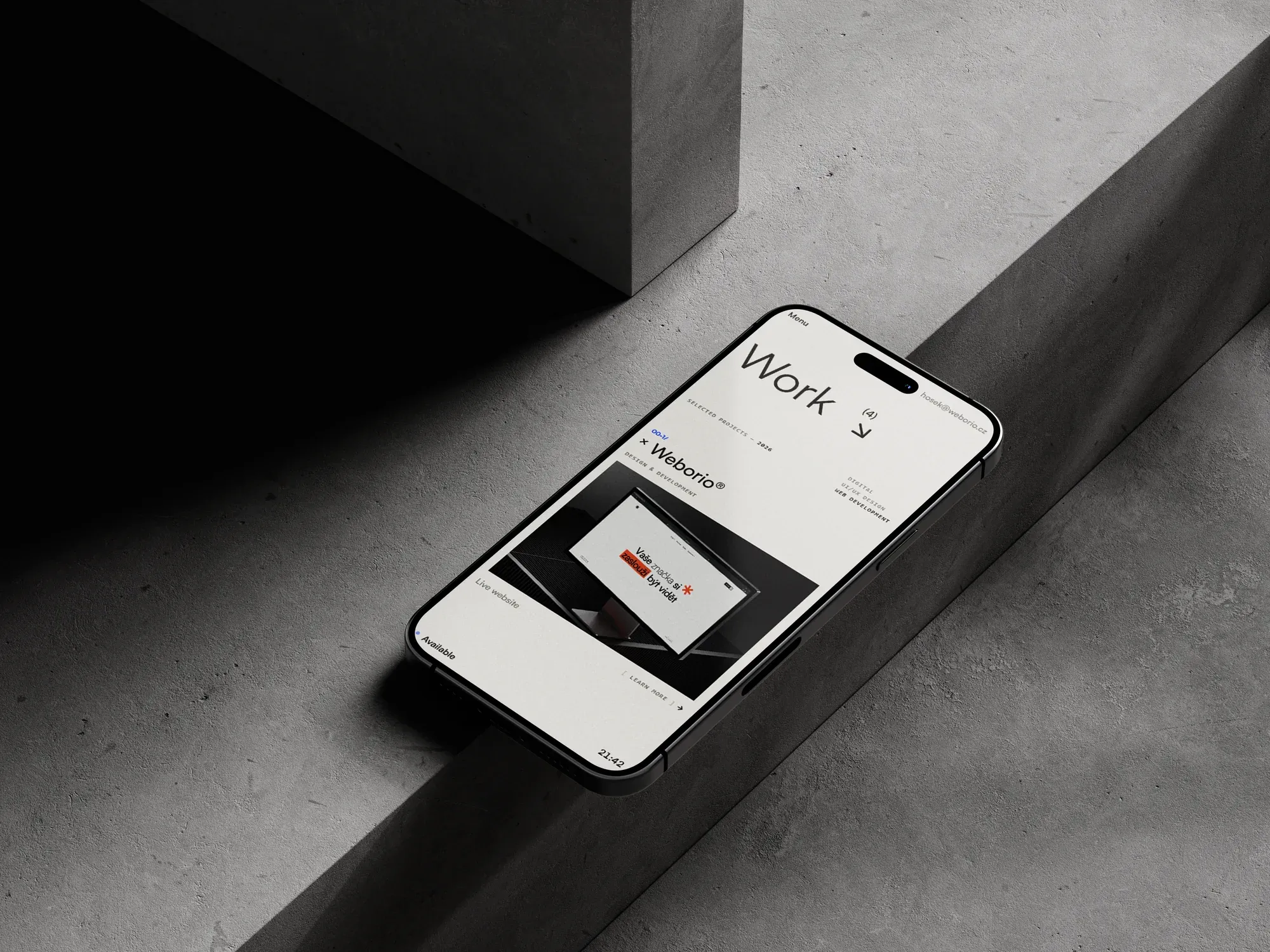 hosek.cc work page on a phone resting on a concrete step
